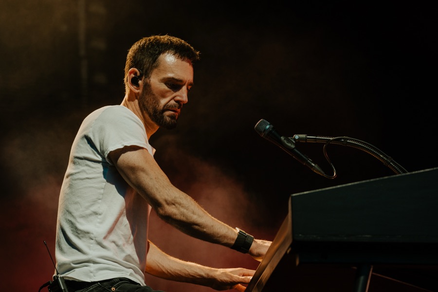 Johnny McDaid at the keyboard in amber stage light